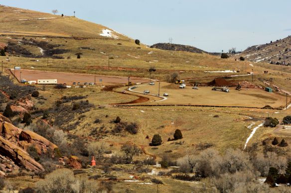 By February 11, the road and parking lot were graveled and sidewalks were in. Cutbanks for the northern intersection were covered with landscape fabric.